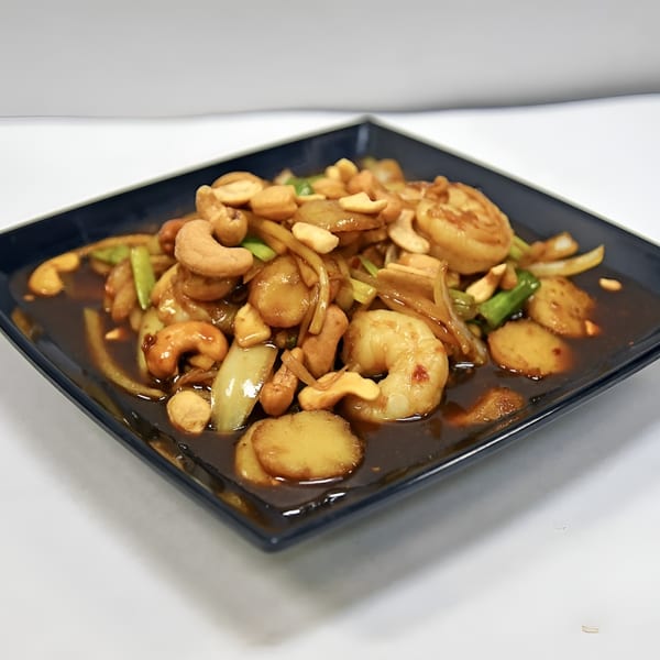 Spicy Bangkok's Cashew Nut Stir-Fry with shrimp, water chestnuts, onions, and green onions in sauce.