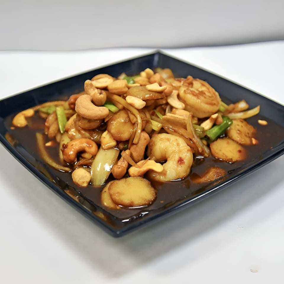 Spicy Bangkok's Cashew Nut Stir-Fry with shrimp, water chestnuts, onions, and green onions in sauce.